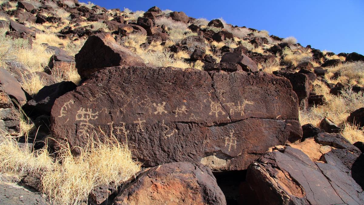 Large stone with Petroglyph markings on a rocky hill