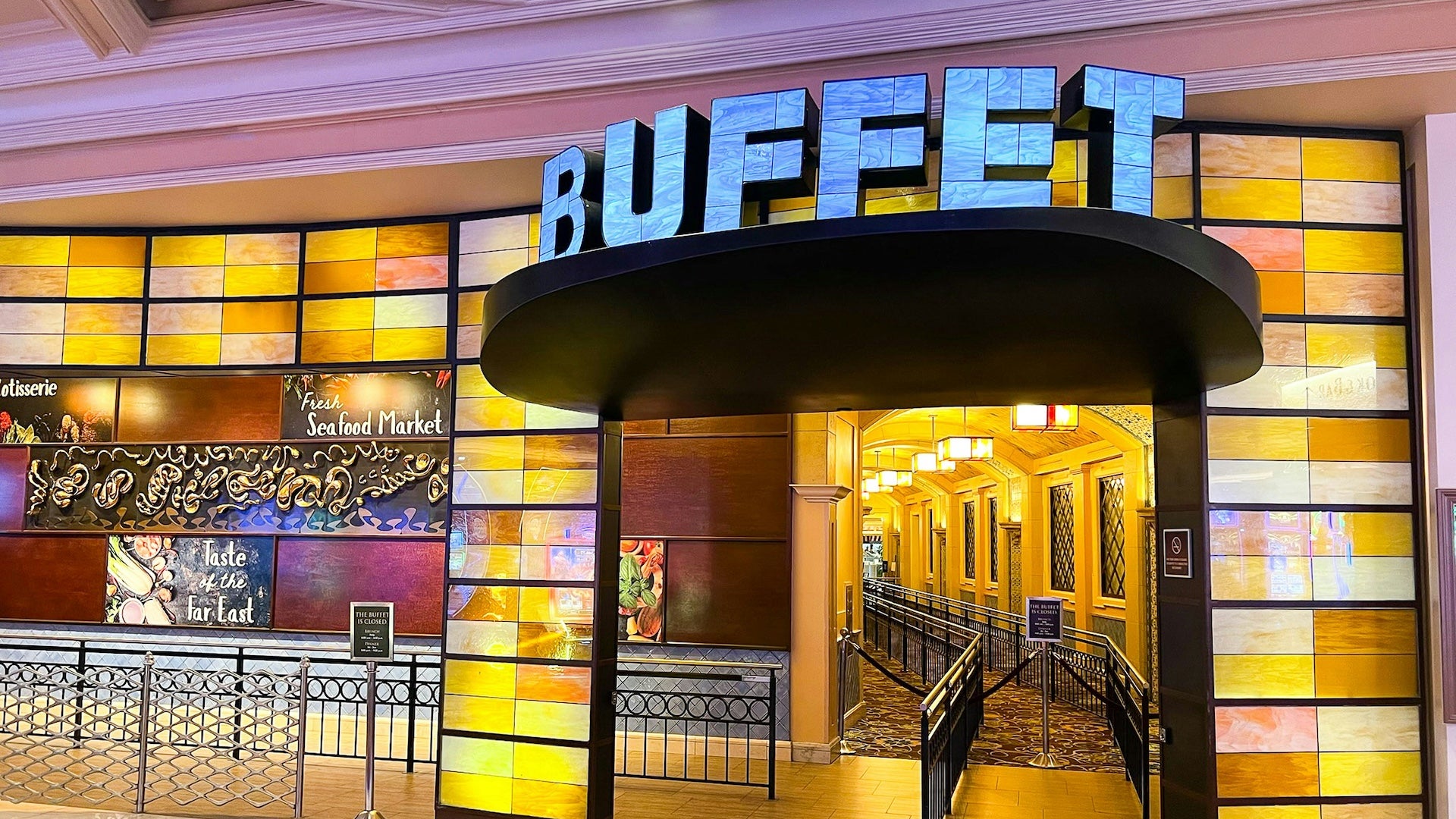 Entrance to a restaurant with a large blue sign that says "Buffet"