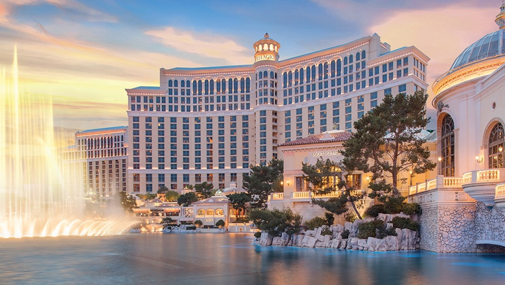 Wide shot at dusk of the bellagio hotel with the fountains in the front