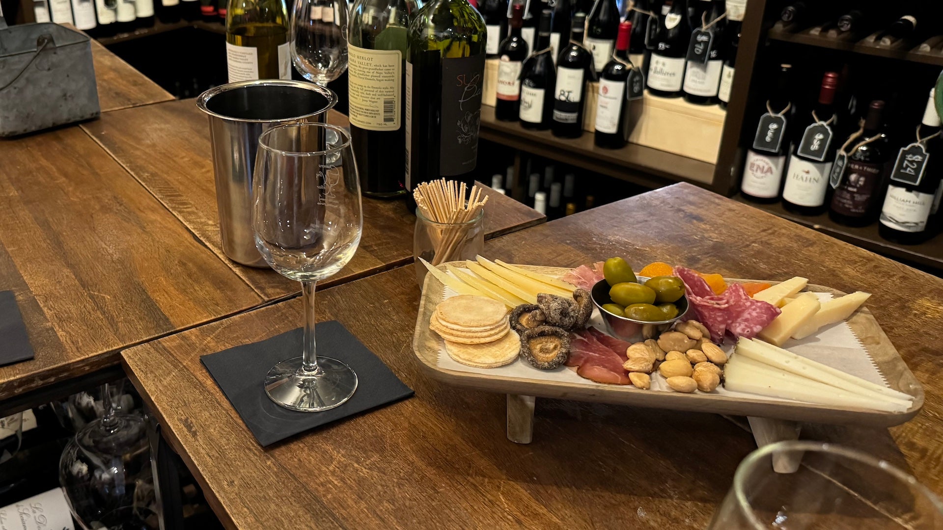 Charcuterie board on a table with a wine glass next to it