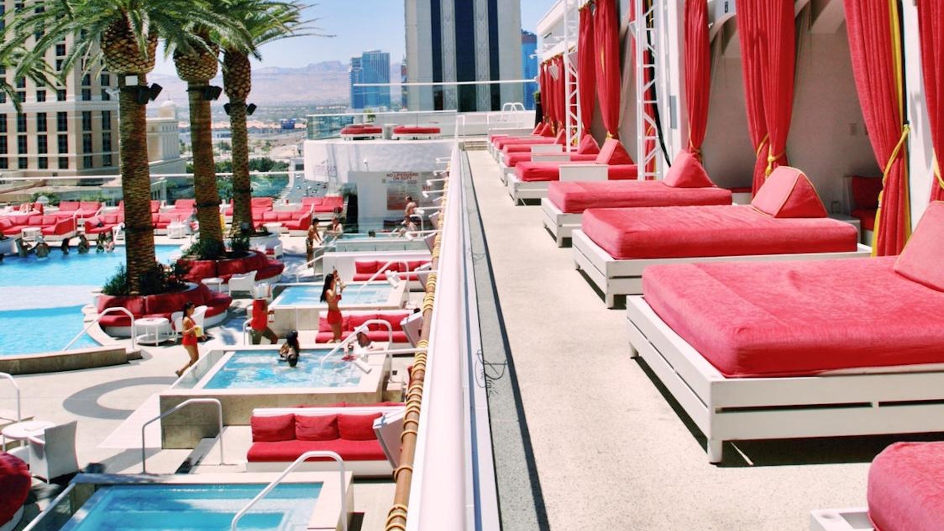Red cabana chairs on a deck overlooking a pool in Las Vegas