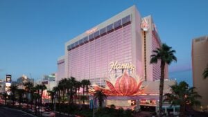 External view of the Flamingo hotel lit up with a pink hue