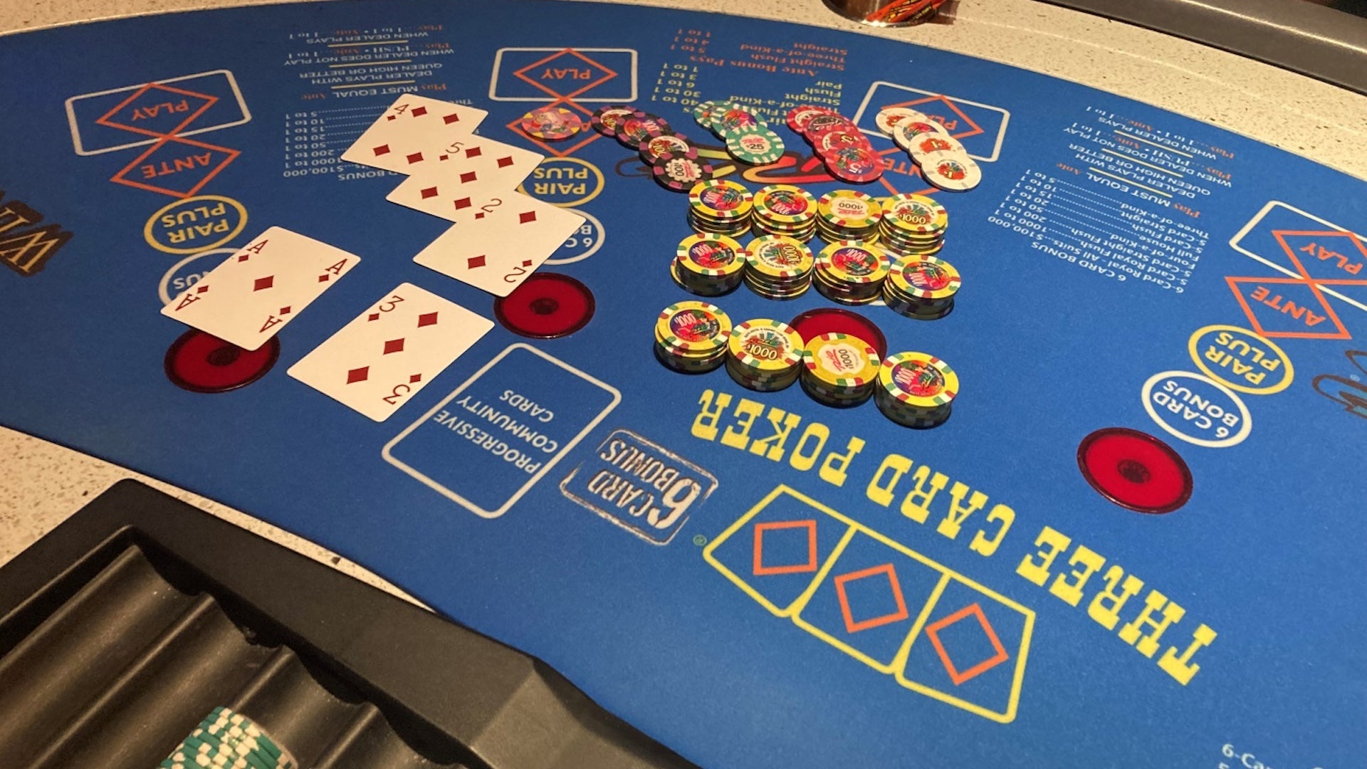 Blue poker table with cards and chips