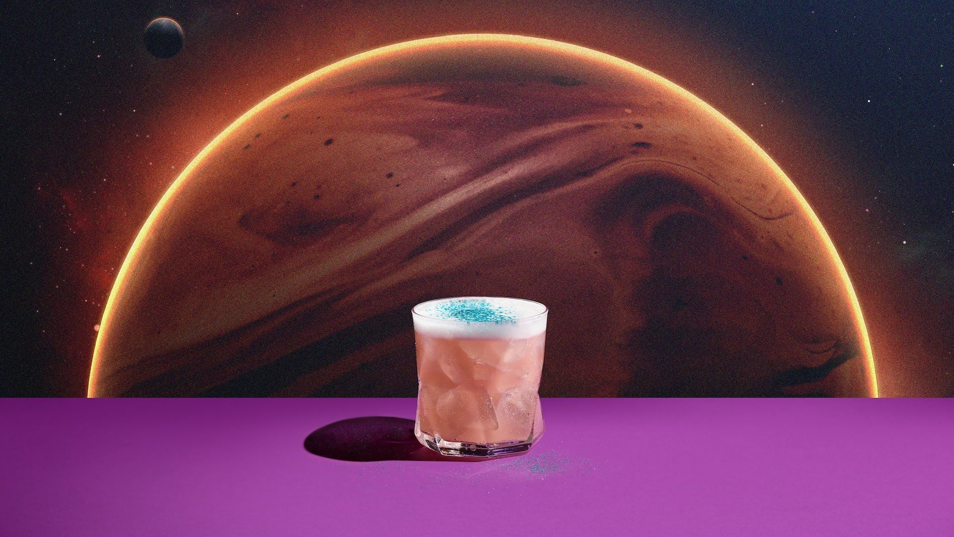 Pink margarita sitting on a purple shelf with a planet wall behind it