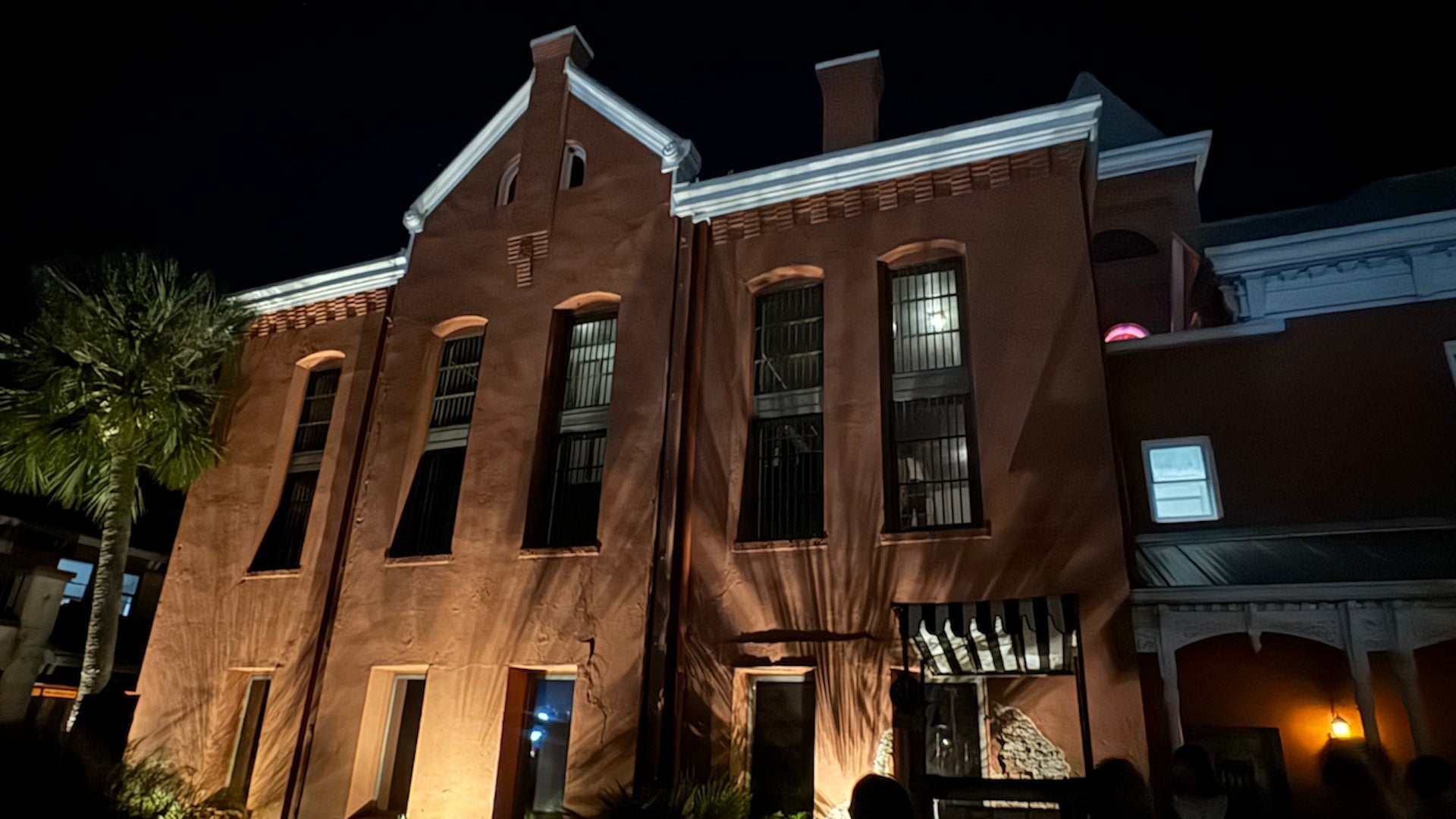 Exterior of old jail building at night