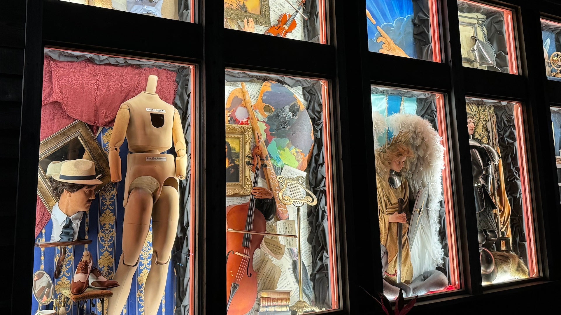 Mannequins and dolls in glass cases