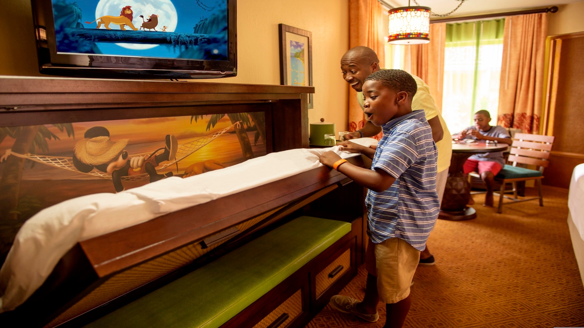 father and son surprised in a room at Disney Caribbean Beach Resort