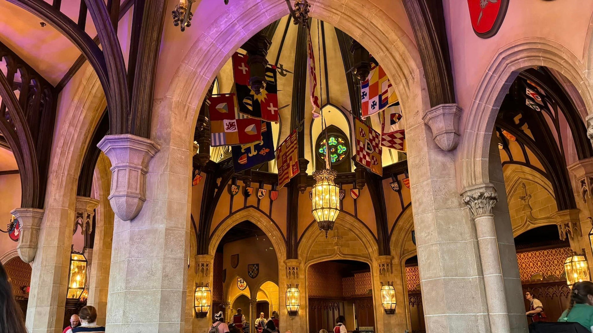 Interior shot of a castle looking up at flags and arched ceilings