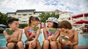 kids laughing and eating in a pool at Disney BoardWalk