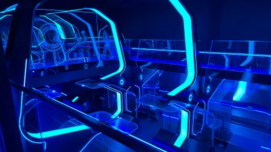 Blue lit walkway inside the Tron Queue