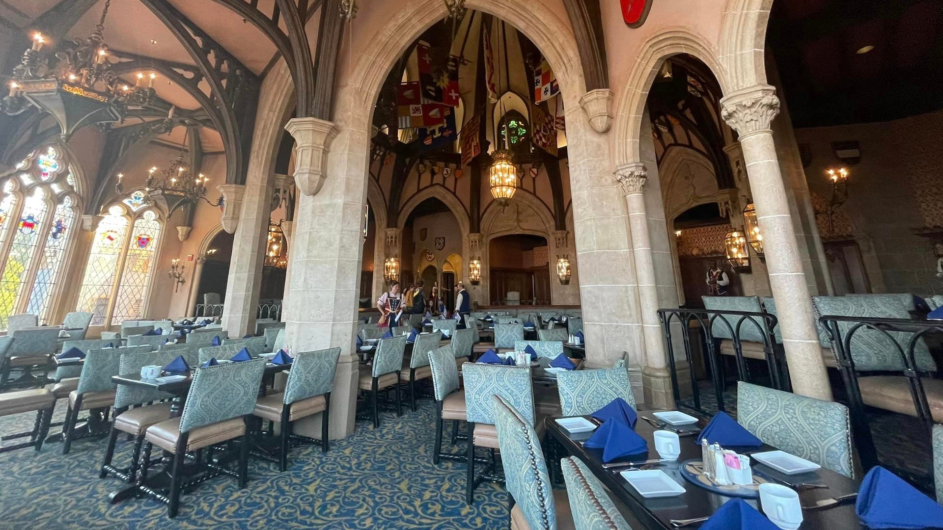 Interior of a castle dining room with high ceilings and tables with chairs