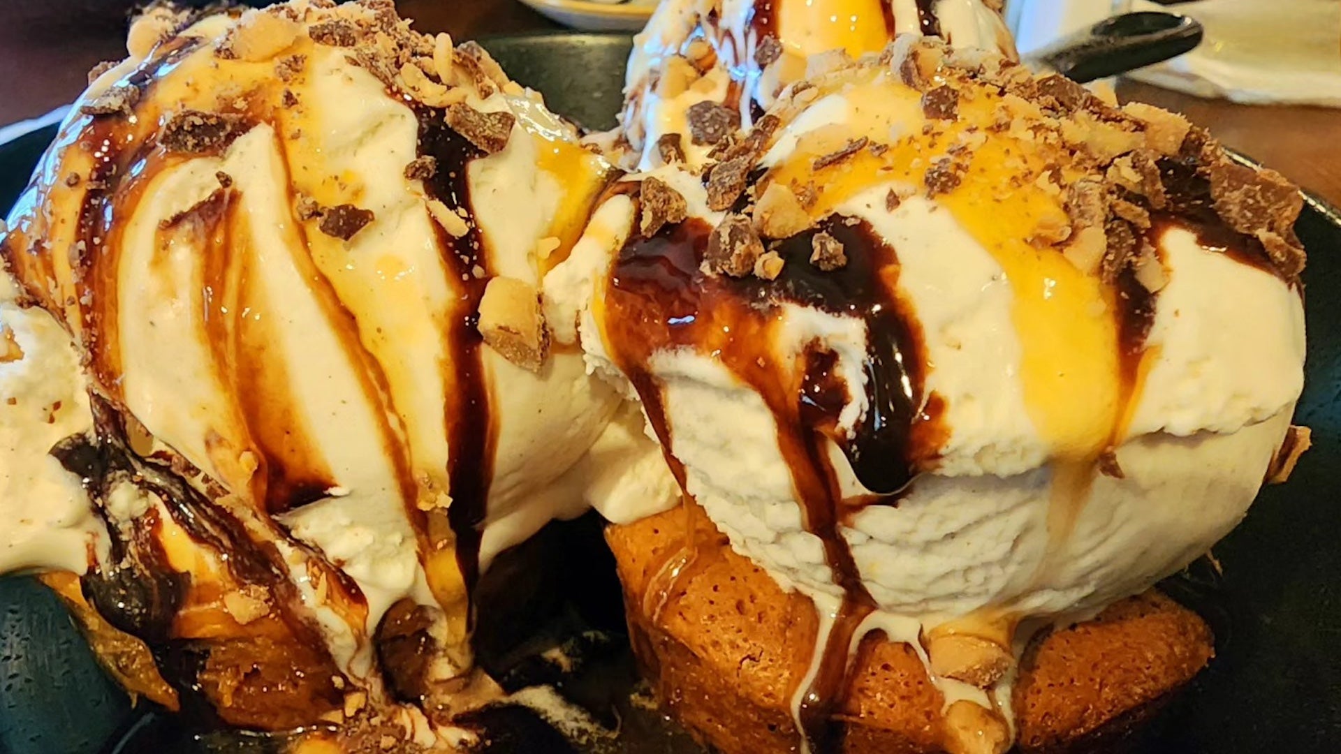Ice cream dessert with caramel and chocolate drizzle