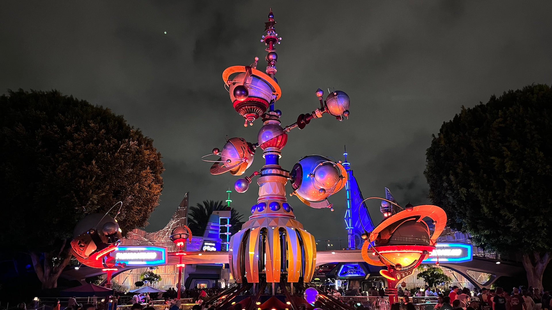 Night shot of a large futuristic statue at Tomorrowland in Disney World