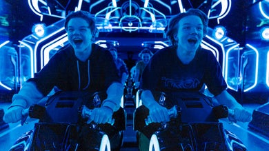 Up close shot of two boys inside the Tron ride about to take off
