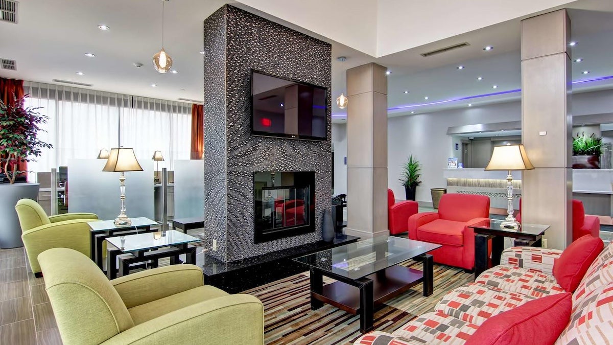 Lobby of hotel room with seating and a fireplace
