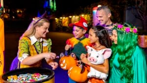 family 'trick or treating' in halloween costumes