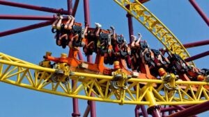 Upside down riders on a yellow roller coaster at Kings Dominion