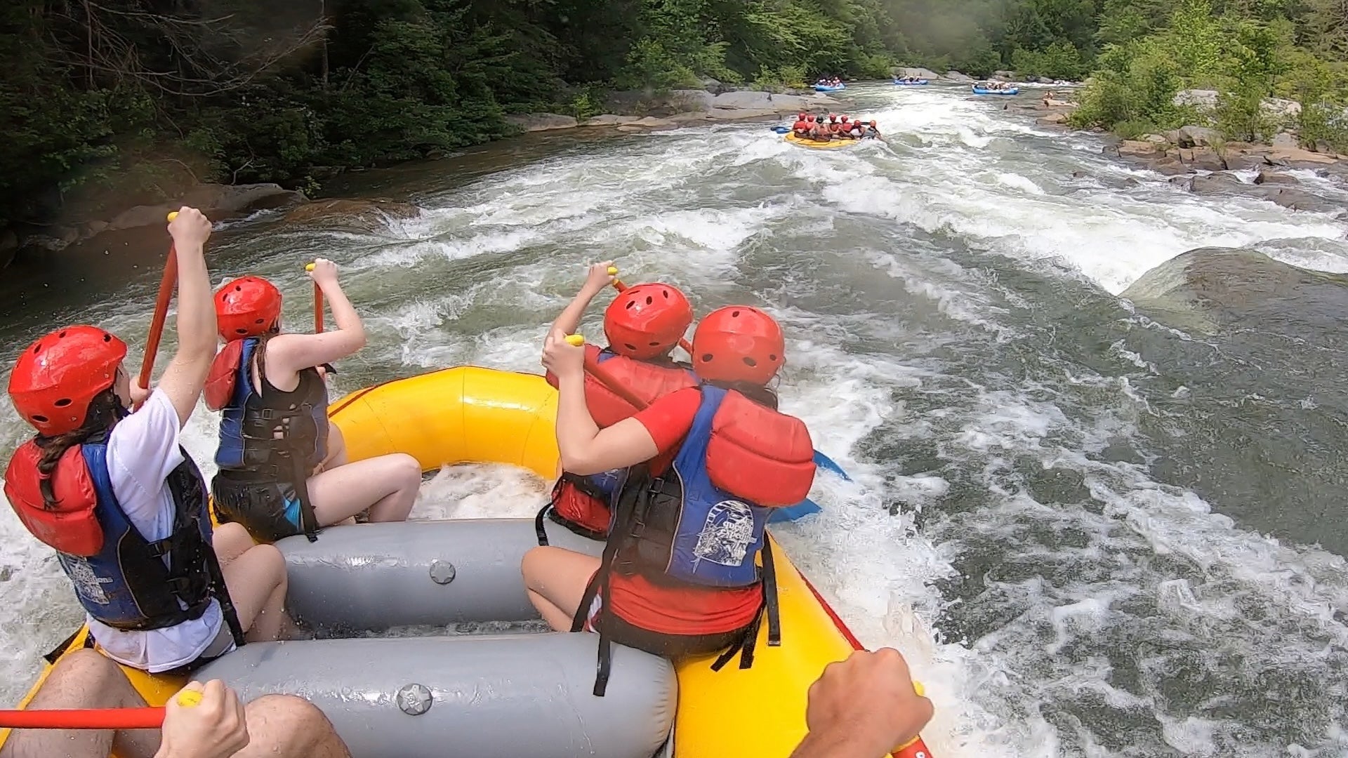 rafting of four people in a boat