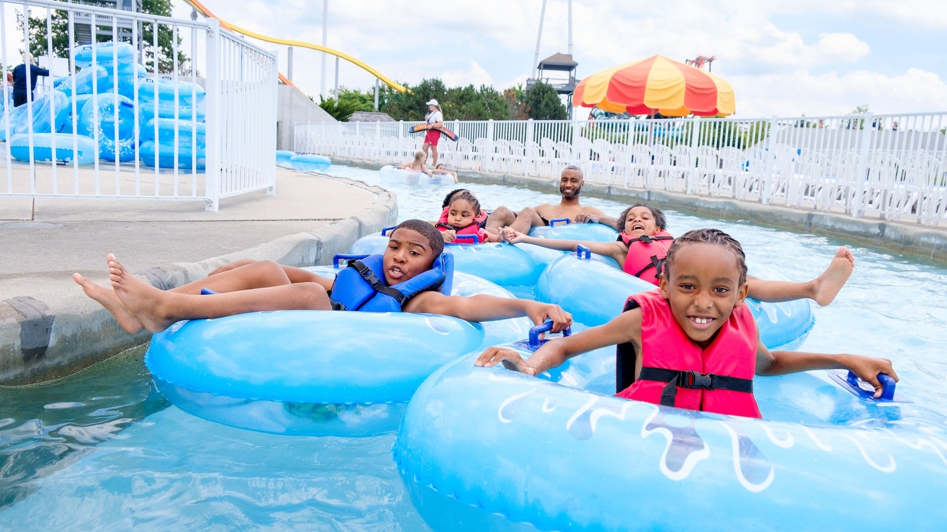 A family enjoying a lazy river while in tubes at Michigan's Adventure