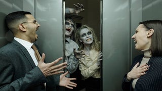 two officer workers stuck in elevator with two ghosts