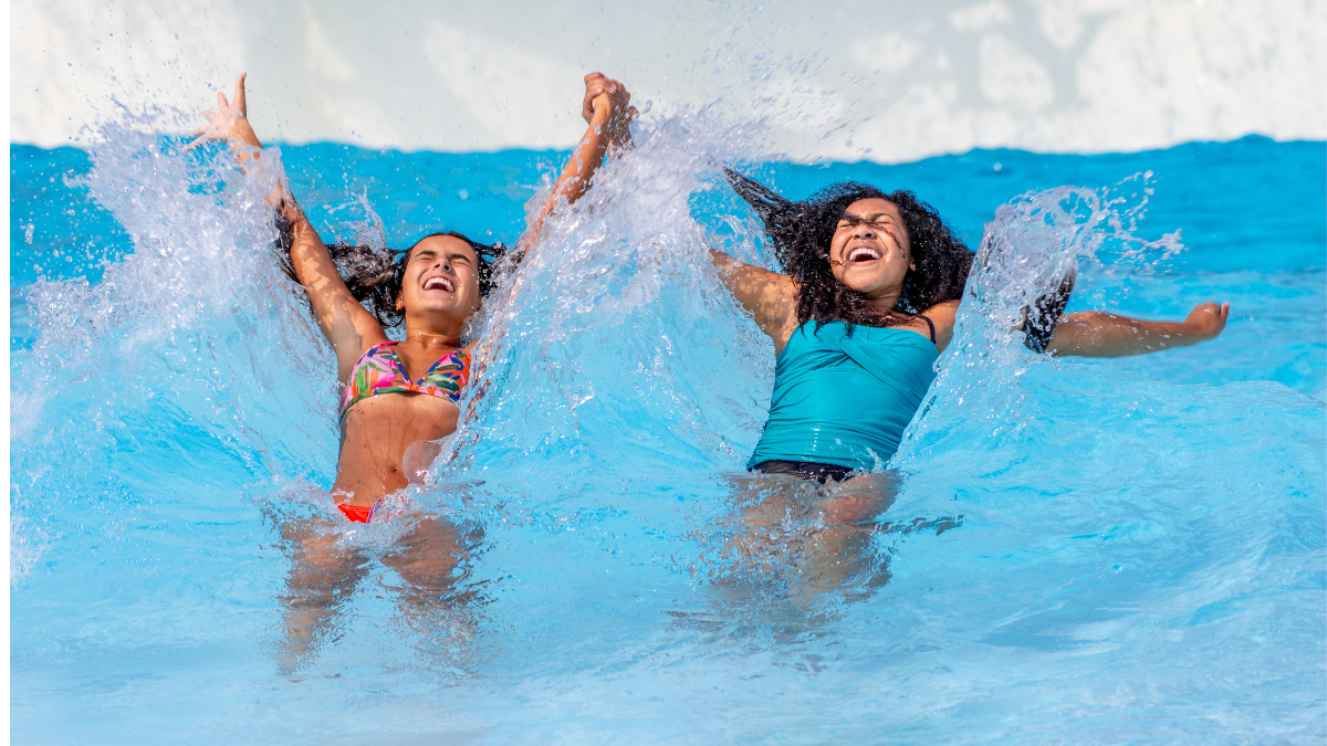 Two girls splashing and having fun in the tide pool at Noah’s Ark Waterpark.