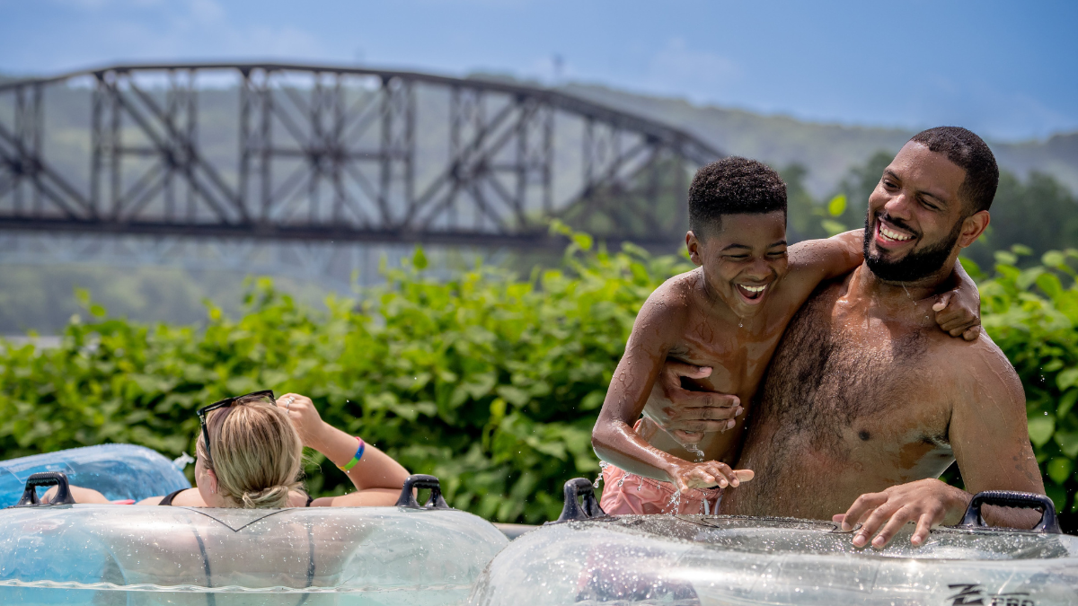 Father and son sharing a joyful moment in the pool at Sandcastle Waterpark.