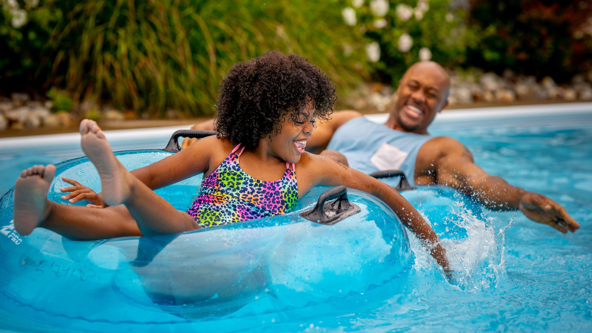 Father and daughter having fun on the lazy river at Sandcastle Waterpark.