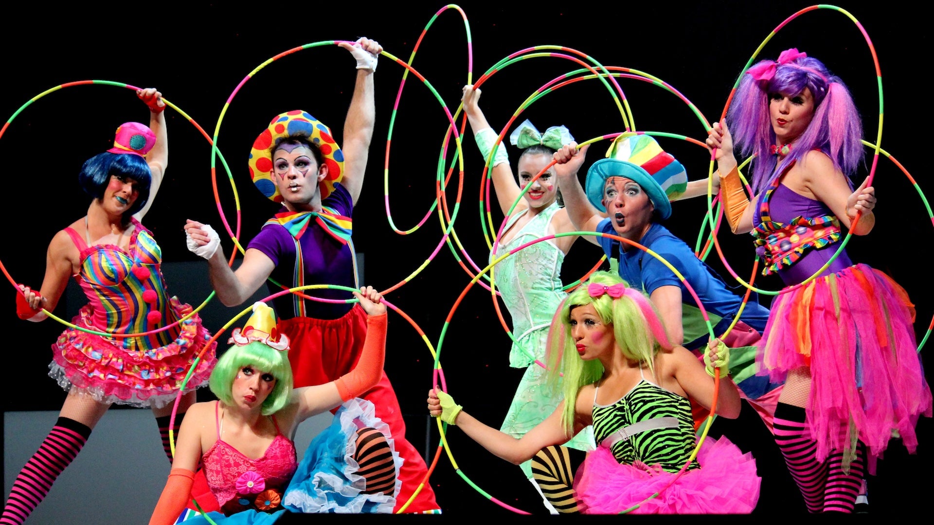 performers with hula hoops and colorful costumes