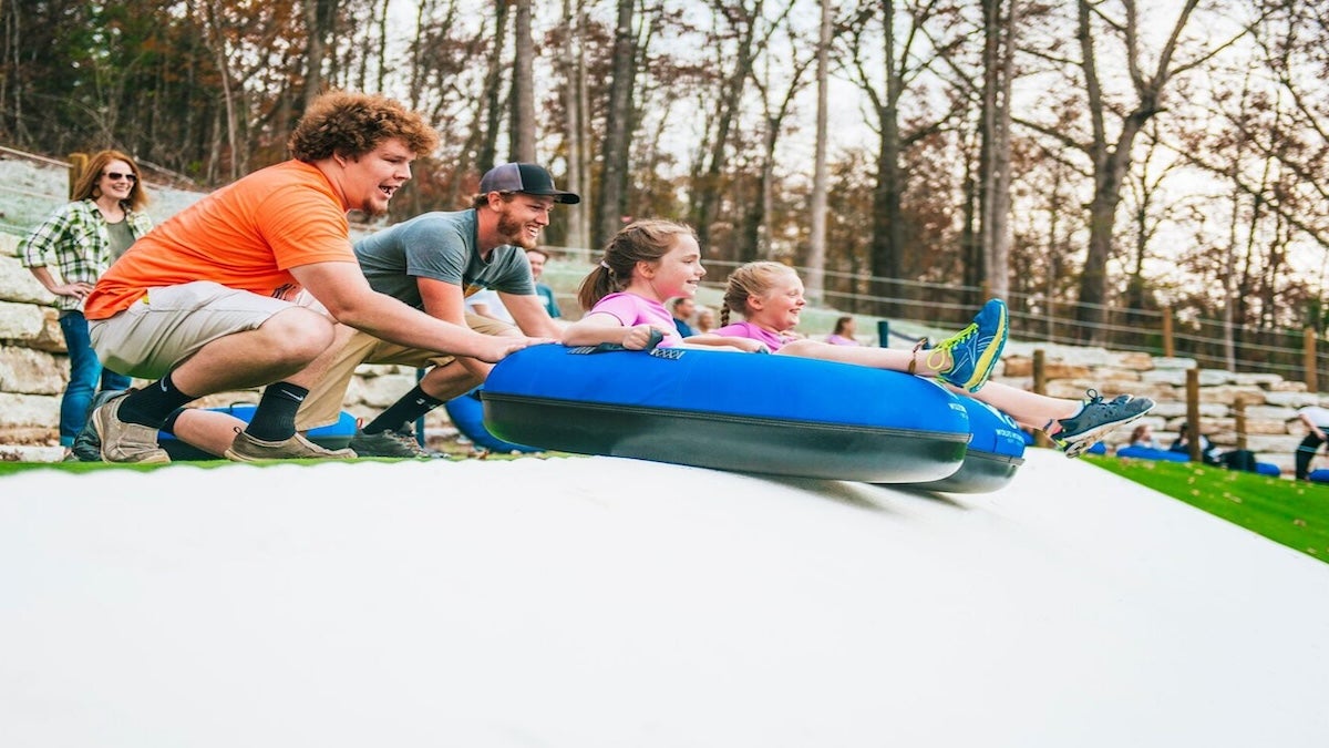 two dads with their daughters playing