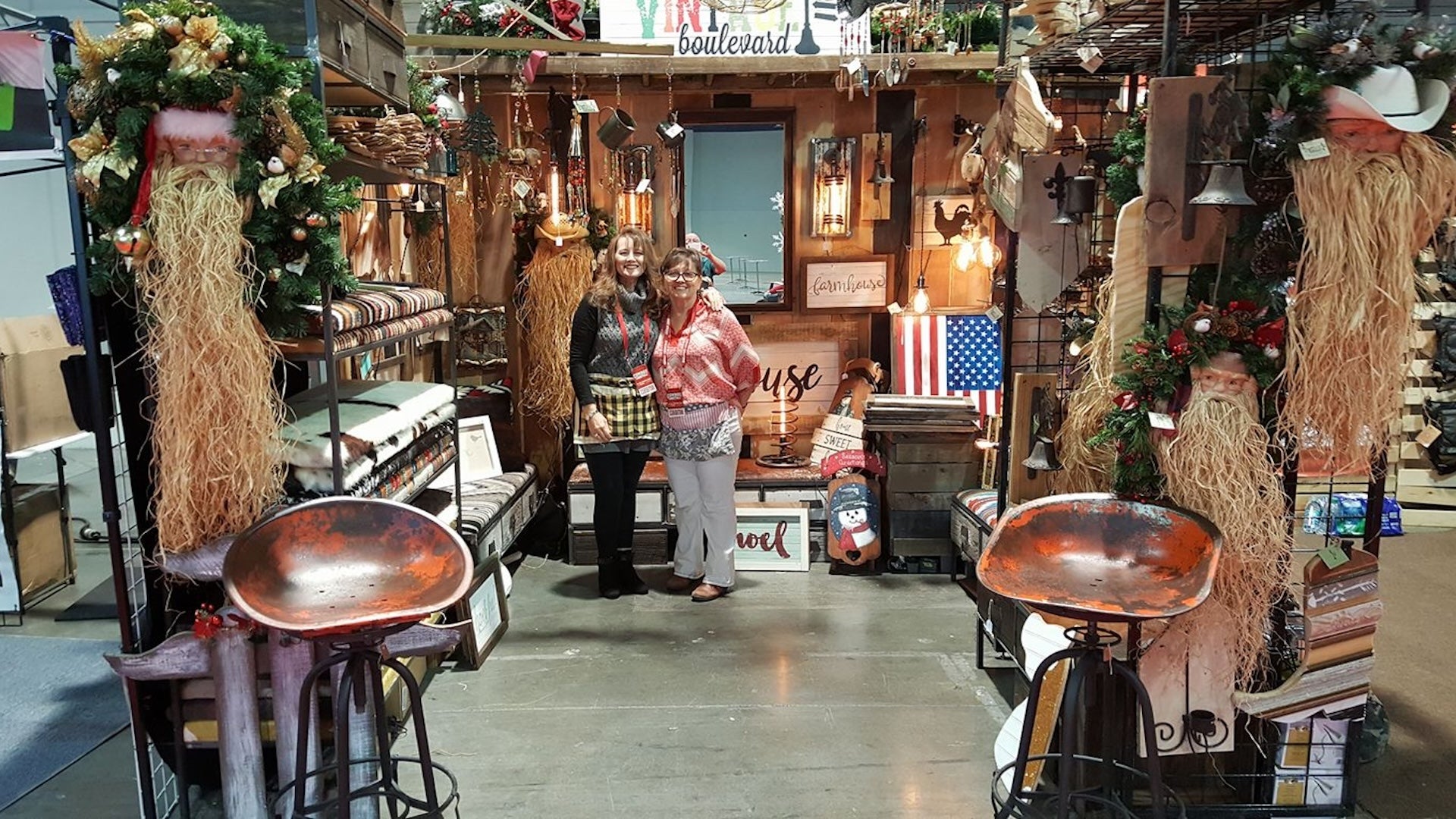 two women posing for a picture in their store at Cowboy Christmas