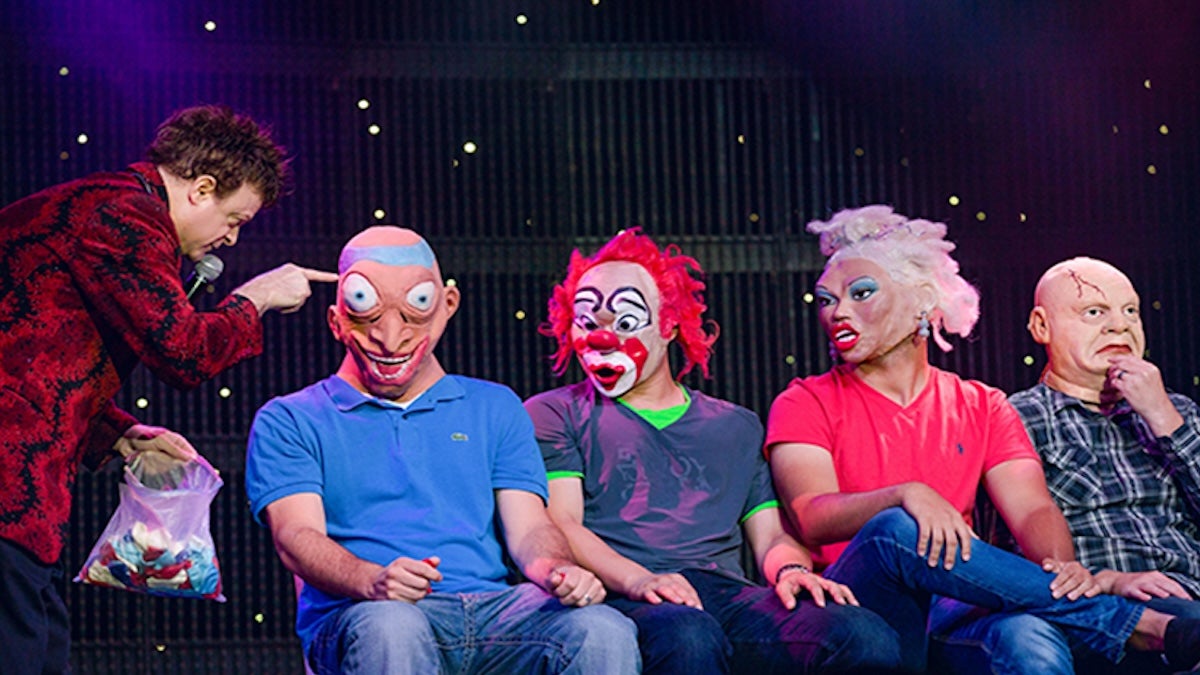 five performers wearing goofy masks