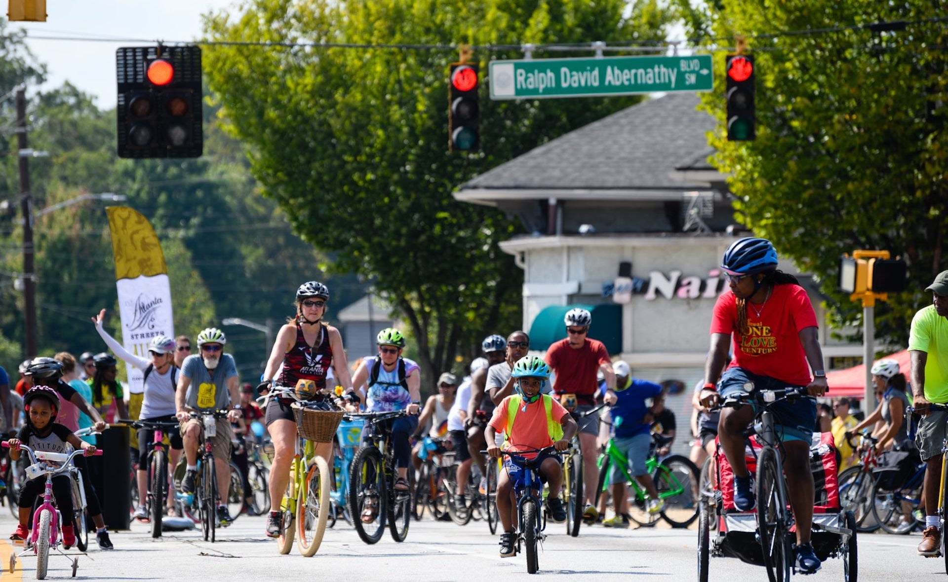 Several people on bikes riding through a street