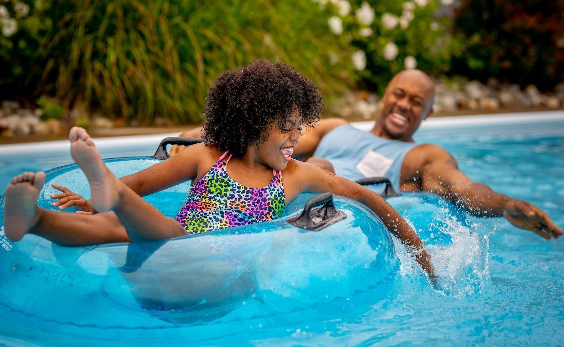 Two people on tubes floating down a lazy river