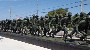 Memorial of ww2 era soldiers marching outside of a museum in Branson