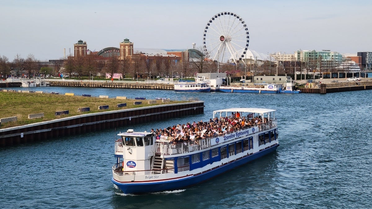 River boat on the water with Navy Pier in the background