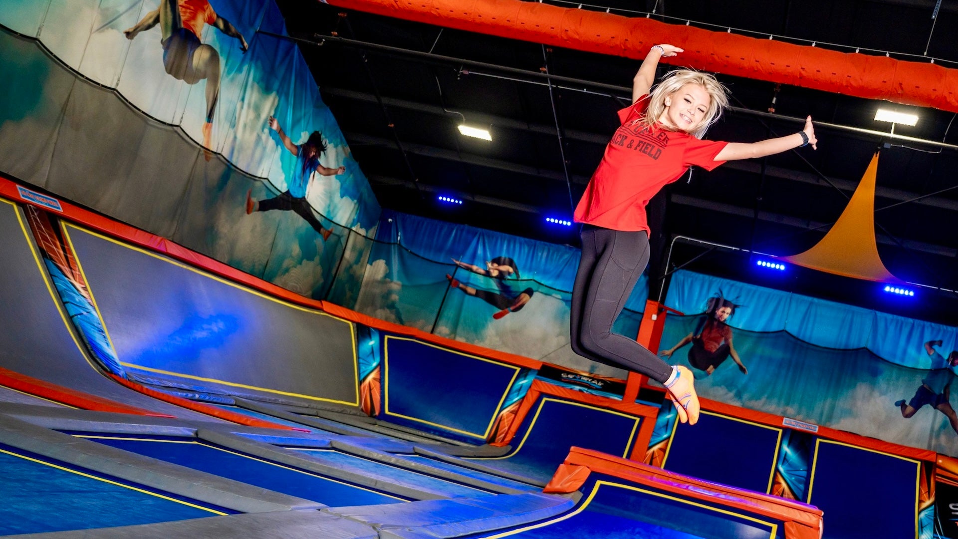 a girl jumping in a trampoline