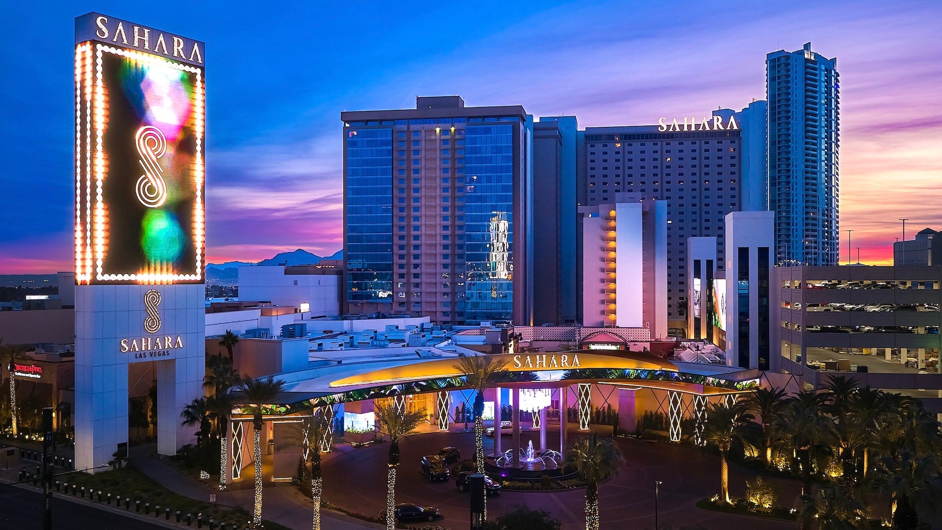 Wide shot of the exterior of the Sahara Las Vegas resort at dusk