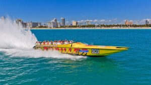 Red and yellow thriller speedboat in the water with Miami skyline in the background