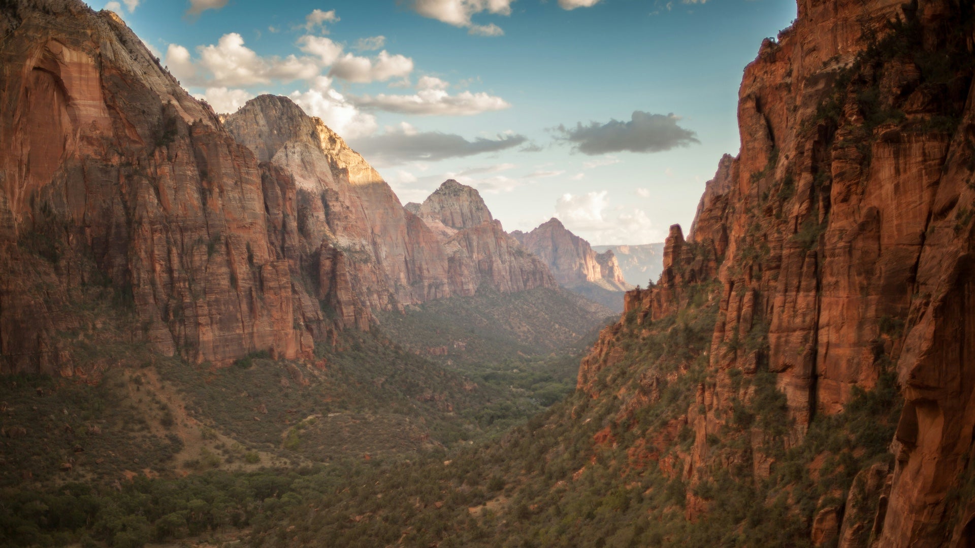 Red rock formations with a green valley in between them