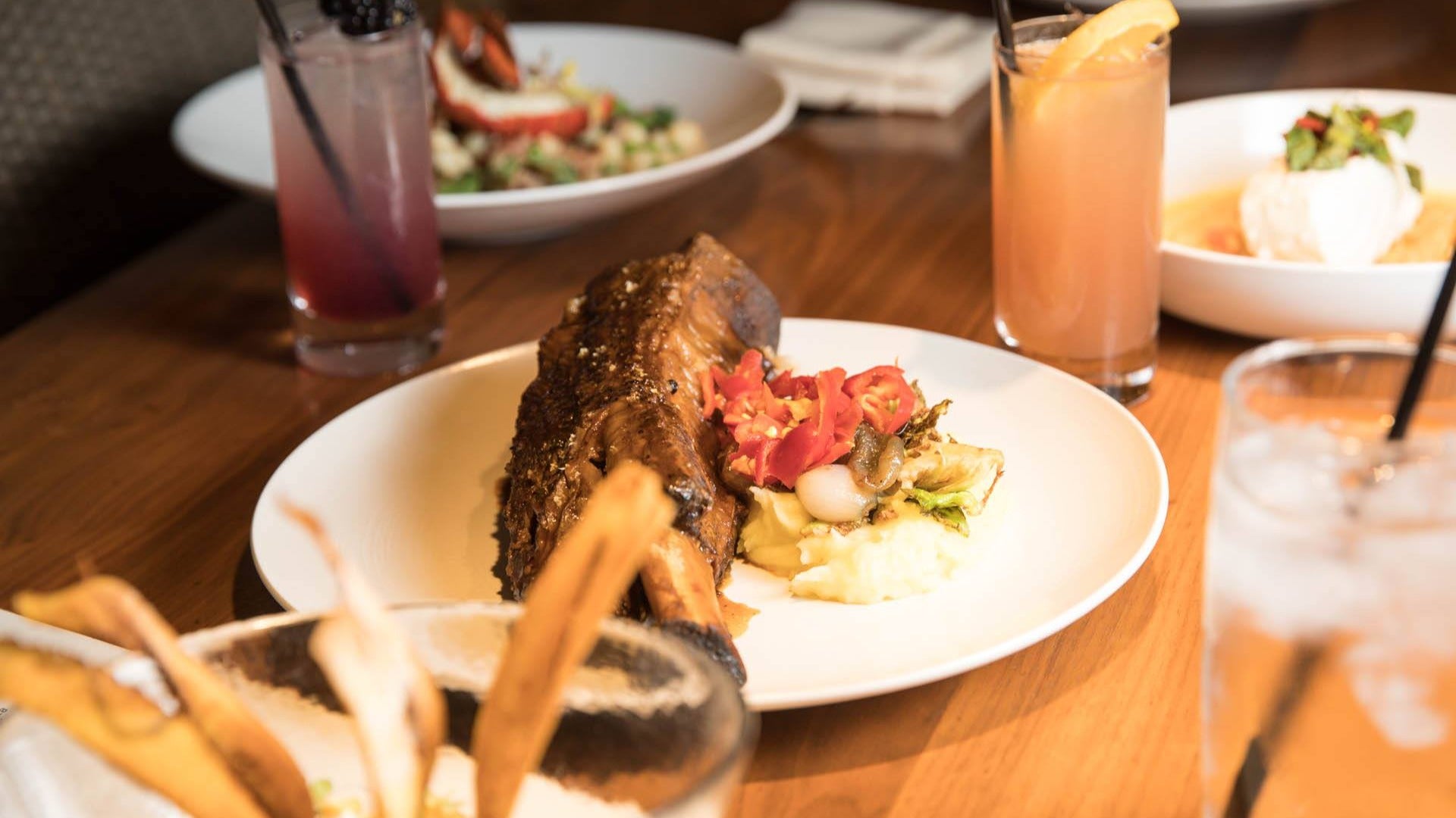 Braised short rib served with a side of mashed potatoes, brussels sprouts and gremolata at Alexxa's Paris Las Vegas