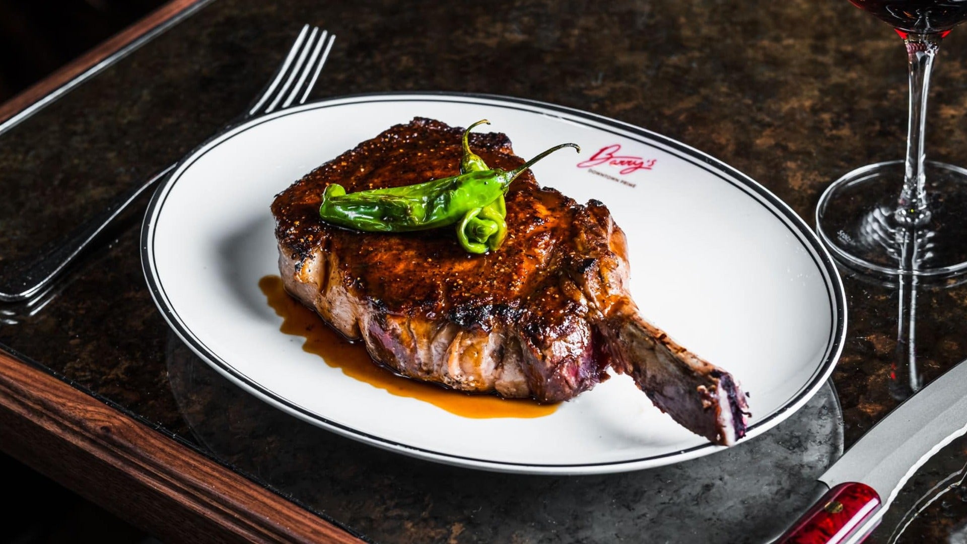 steak served on a plate with cutlery on the side