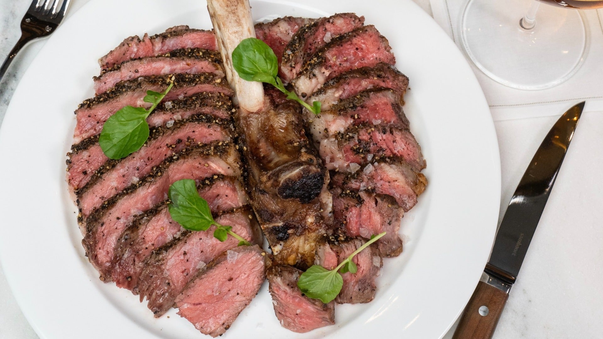 24 oz. Prime Bone-in Ribeye at Bedford by Martha Stewart at Paris Hotel Las Vegas, plate with steak knife and fork