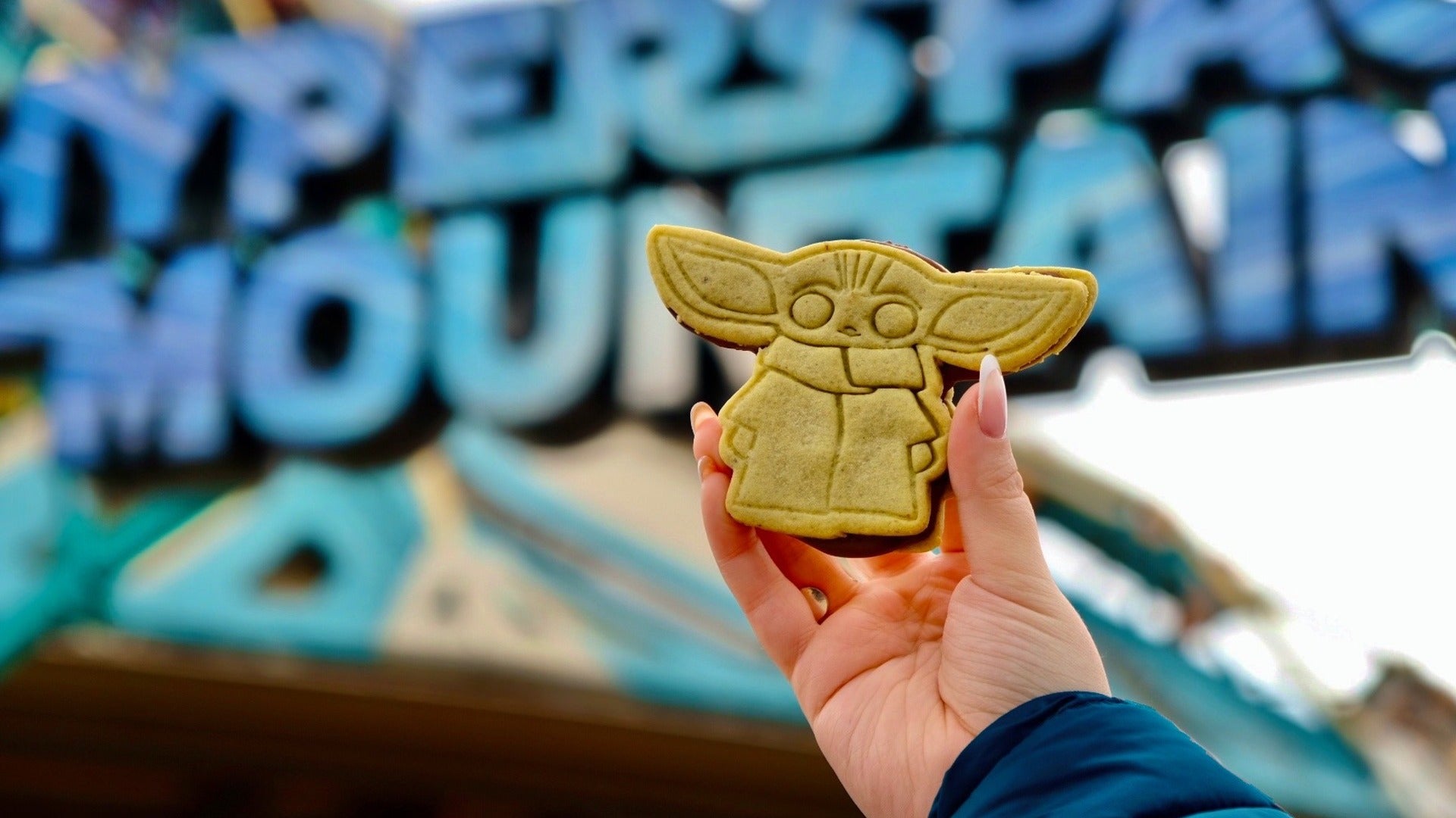 baby yoda churro held by someone