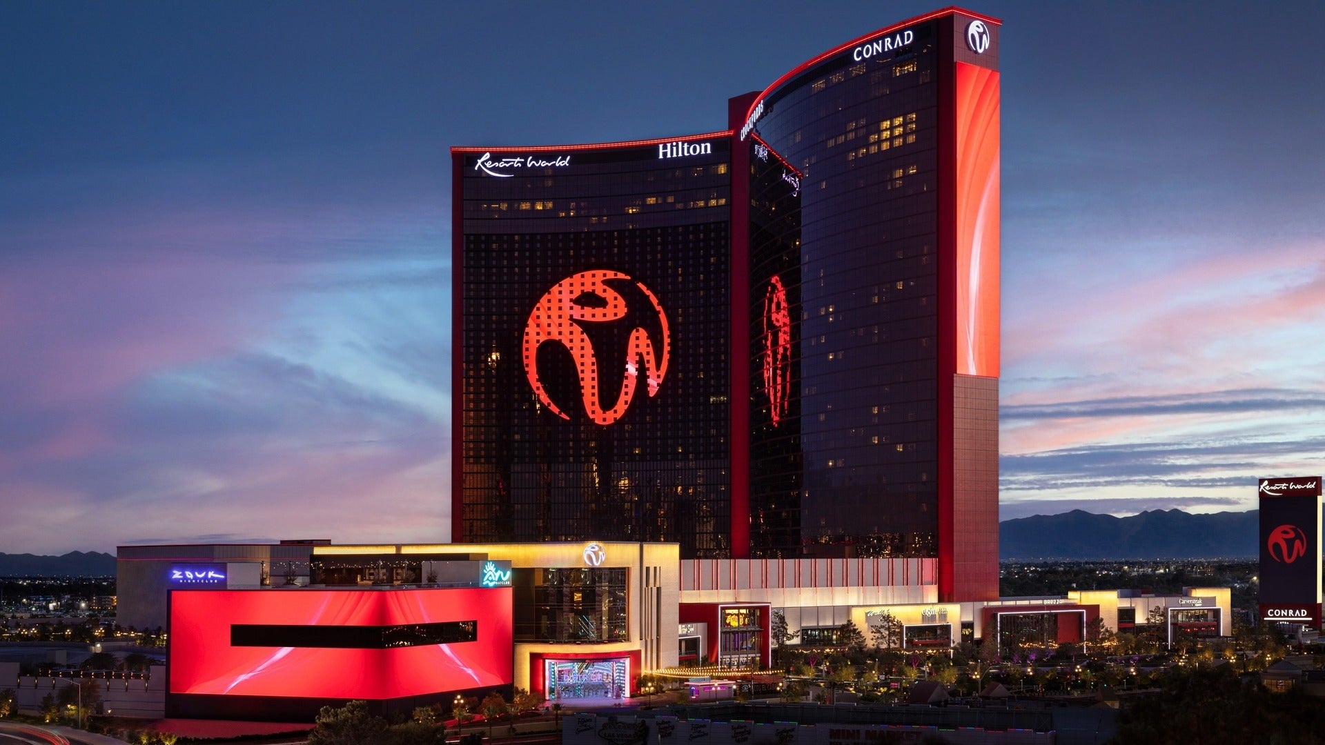 exterior of resorts world las vegas and conrad hotel, buildings below