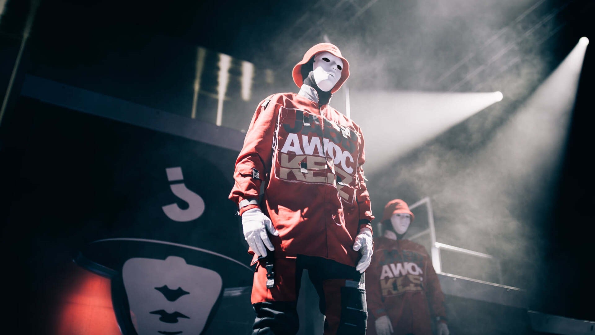 dancer on stage wearing red jacket with light, jabbawockeez members