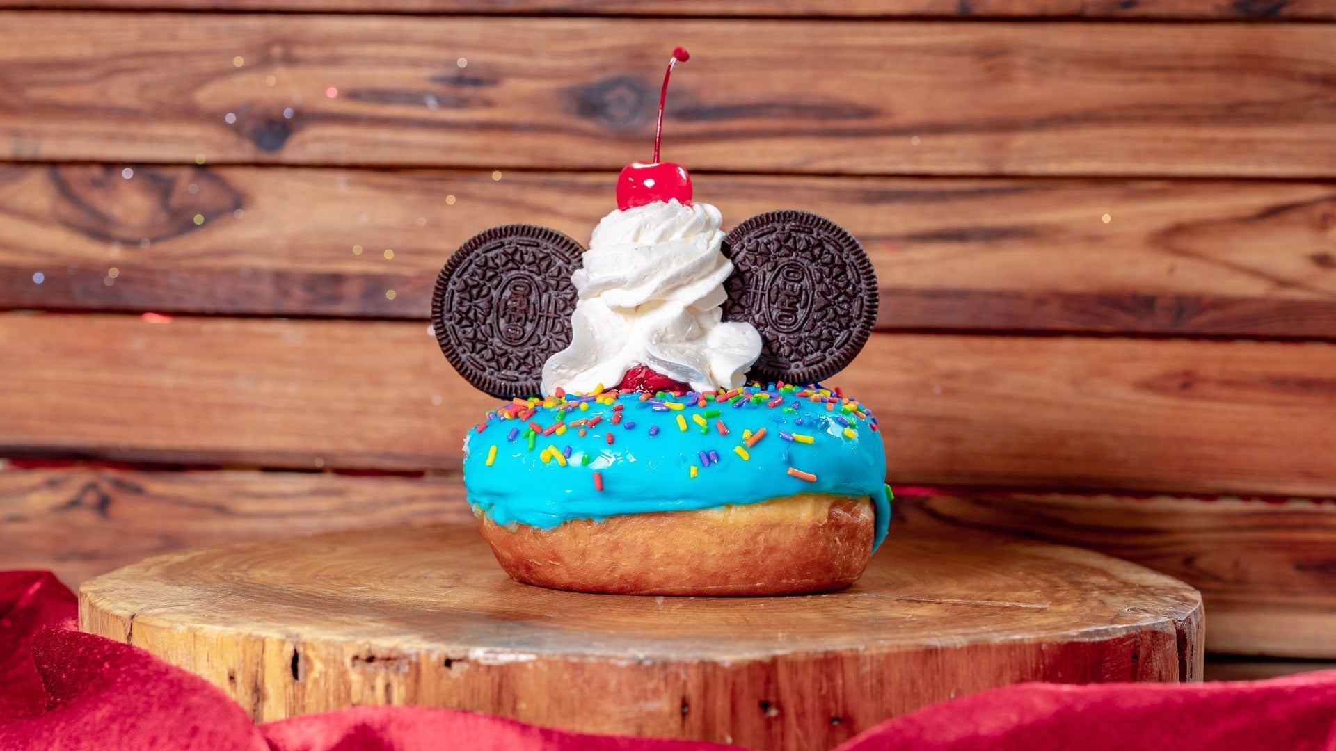 donut with sprinkles and oras as micky ears with whipped cream and cherry