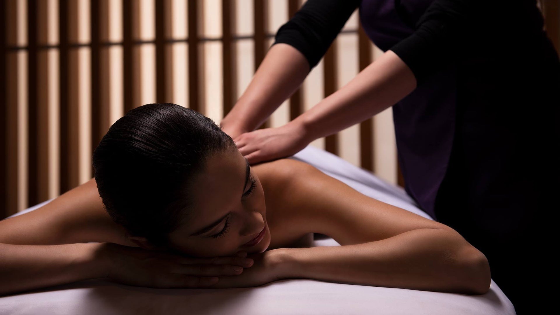 A woman relaxed on a massage table receiving a massage