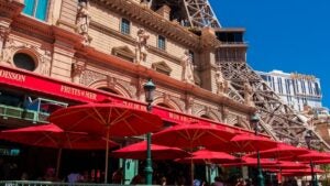 mon ami gabi at paris hotel in las vegas, red umbrellas, eiffel tower, and statues at the back