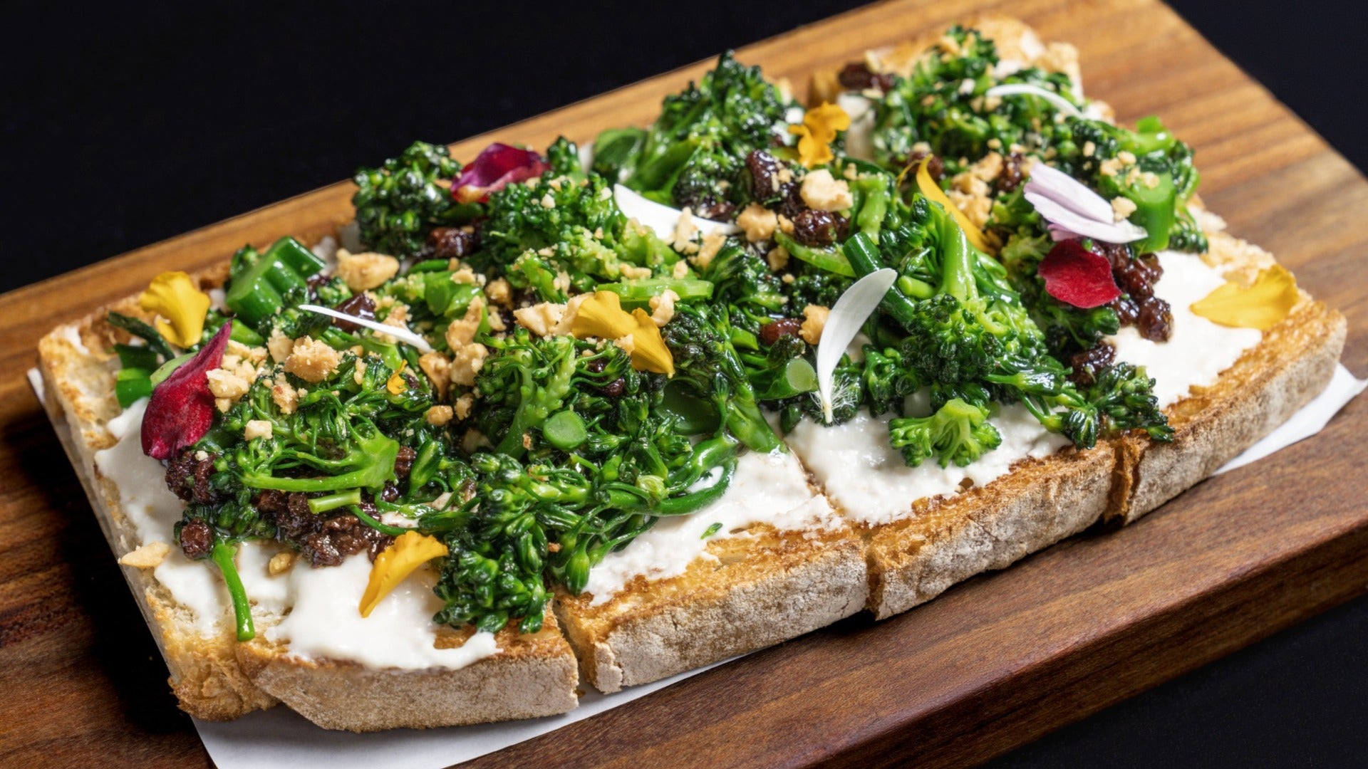 Brocolinni Bruschetta, vegetables on bread served on a wooden platter, food item