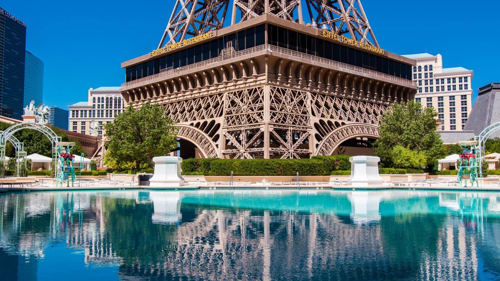 paris hotel pool with the eiffel tower and restaurant in the background, daytime